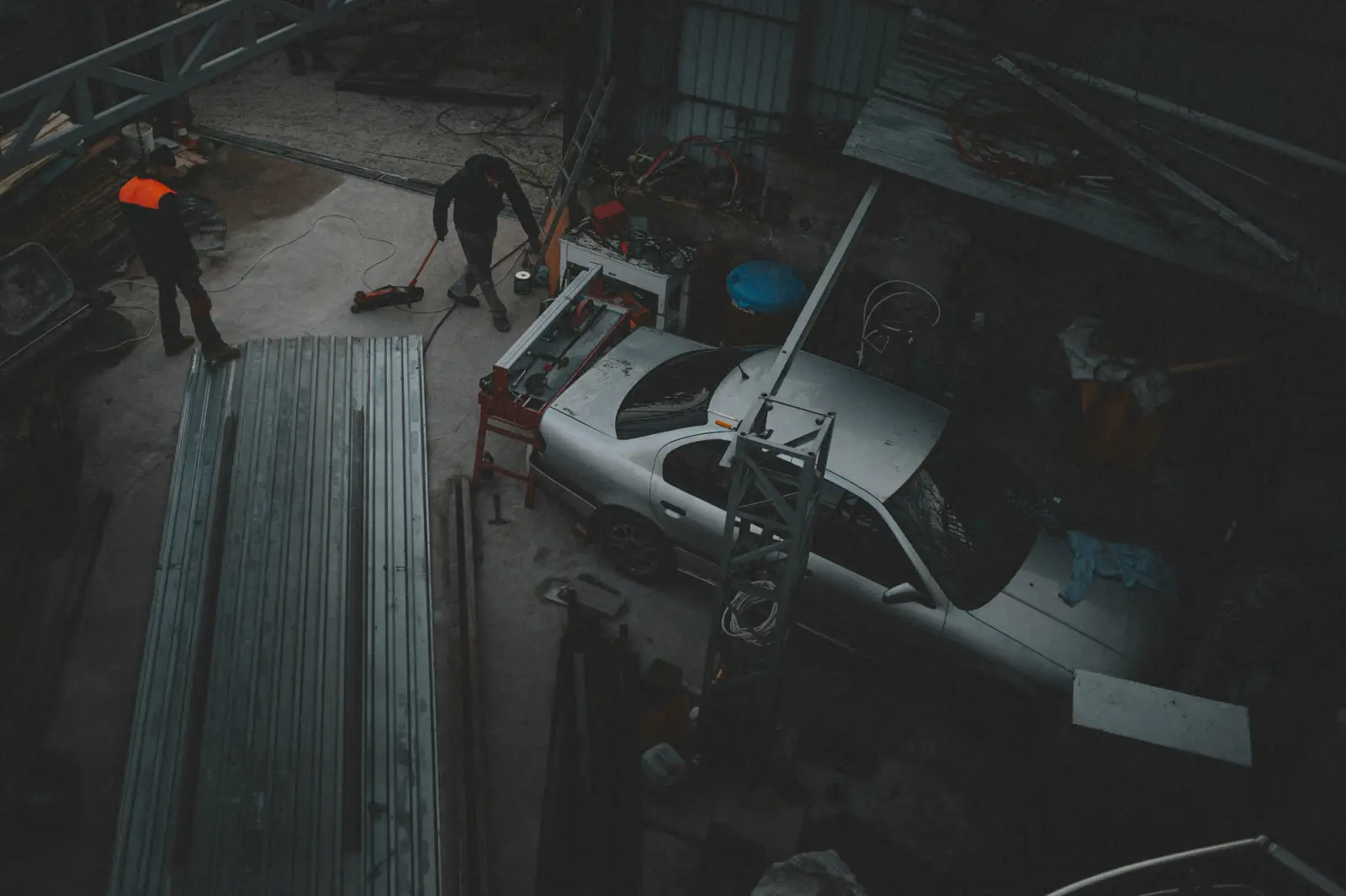 Two technicians working on a car in the shop