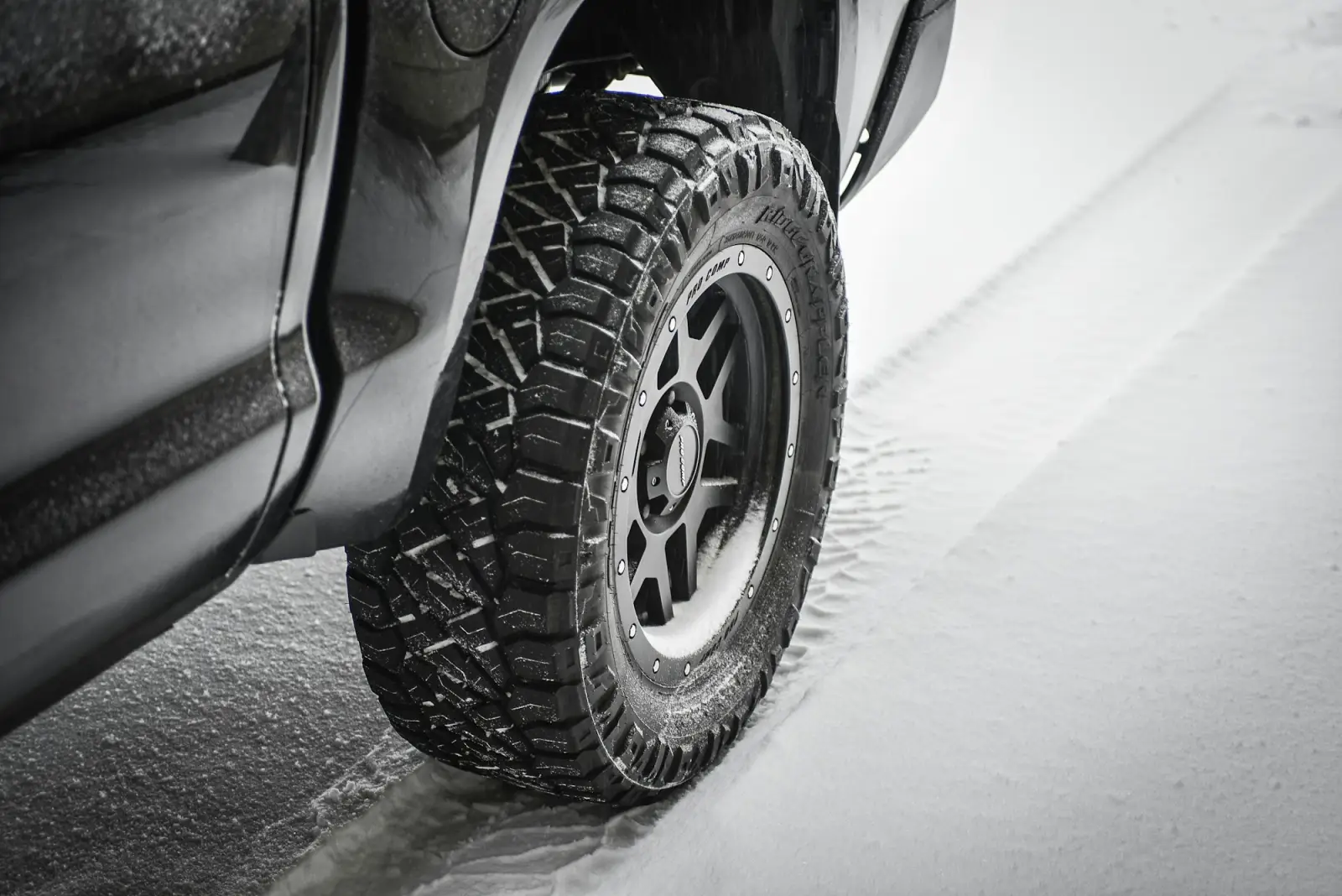 Winter tire on a vehicle in fresh snow